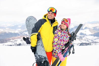 Lovely couple with equipment at ski resort. Winter vacation