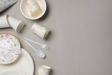 Disposable tableware on light grey background, flat lay. Space for text
