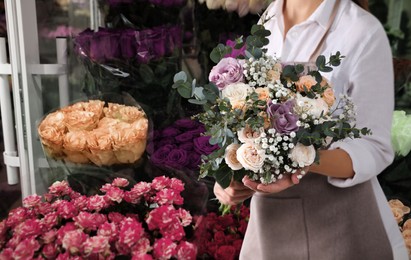Florist holding beautiful wedding bouquet on shop, closeup