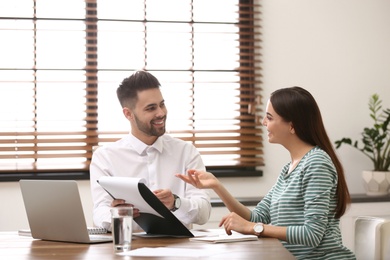 Insurance agent consulting young woman in office