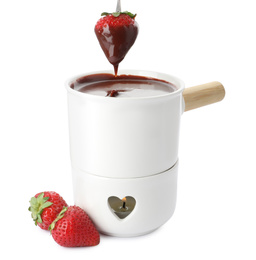Dipping strawberry into fondue pot with chocolate on white background