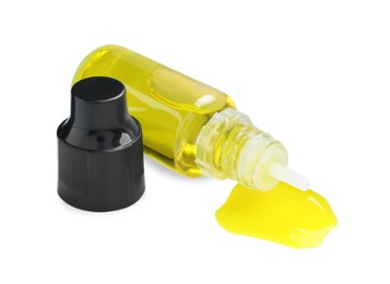 Photo of Bottle of yellow food coloring on white background