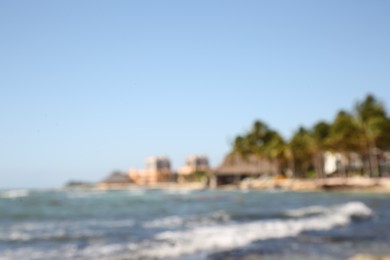 Photo of Blurred view of tropical beach and sea on sunny day