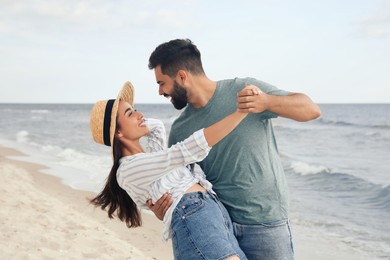 Lovely couple dancing on beach. Time together