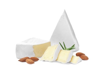 Tasty cut brie cheese with rosemary and almonds on white background