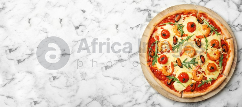 Image of Top view of hot delicious pizza on white marble table, space for text. Banner design 