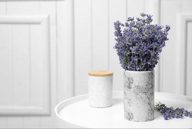 Fresh lavender flowers in vase on table against white wooden background, space for text