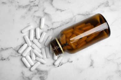 Amino acid pills on white marble table, flat lay