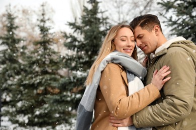 Beautiful happy couple outdoors on winter day