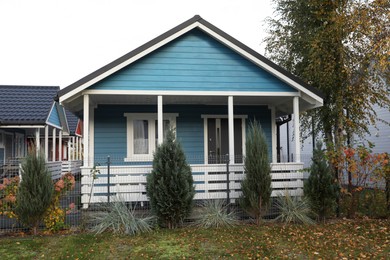 Photo of Beautiful light blue house outdoors. Real estate