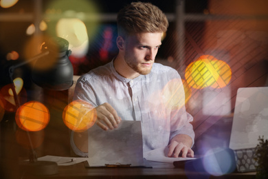 Double exposure of young man working in office and cityscape. Financial analytics