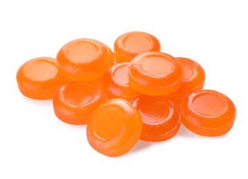 Many orange cough drops on white background