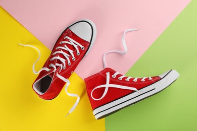 Pair of trendy sneakers on color background, flat lay