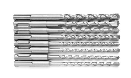 Many twist drill bits isolated on white, top view. Carpenter's tools