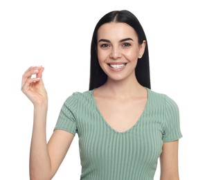 Young woman snapping fingers on white background