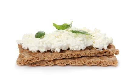 Photo of Crispy crackers with cottage cheese and basil on white background