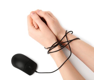 Photo of Woman showing hands tied with mouse cable on white background, top view. Internet addiction