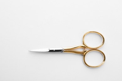 Pair of sharp sewing scissors on white background