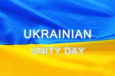Text Ukrainian Unity Day and national flag on background