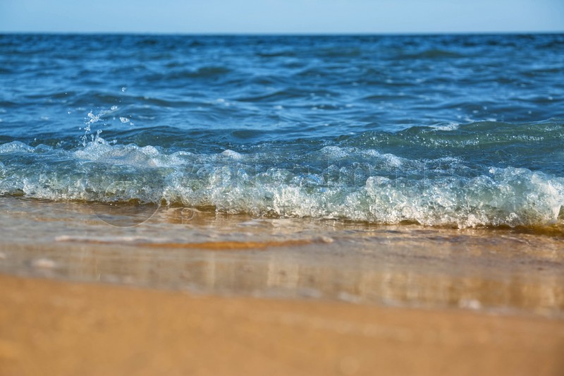 Beautiful view of sea waves on beach, closeup