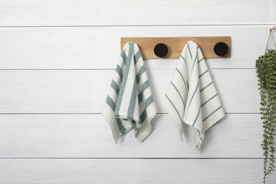 Different clean kitchen towels hanging on rack