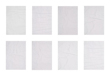 Collection of creased blank posters on white background