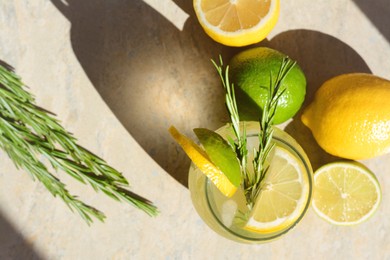 Photo of Summer refreshing lemonade and ingredients on light grey table, flat lay. Space for text