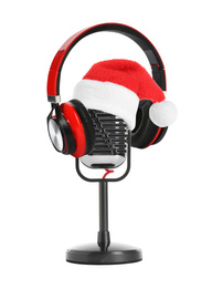 Retro microphone with Santa hat and headphones on white background. Christmas music concept
