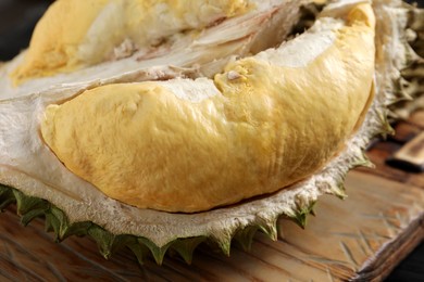 Fresh ripe durian on wooden board, closeup