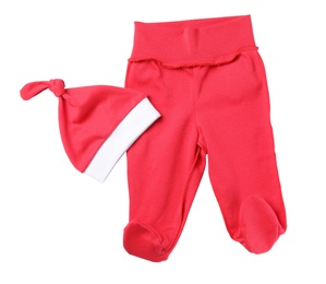 Red footed pants and hat on white background, top view. Christmas baby clothes