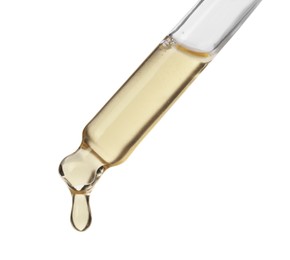 Dripping hydrophilic oil from pipette on white background