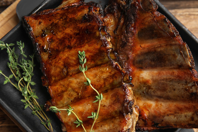 Photo of Tasty grilled ribs with thyme, above view