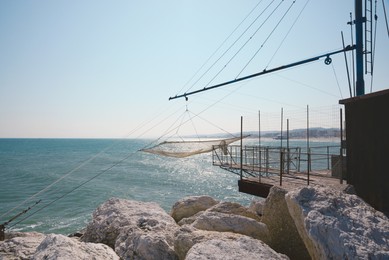 Shore operated stationary lift net on coast