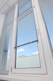 Photo of Window with horizontal blinds indoors, low angle view