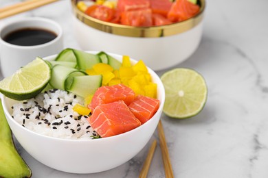 Photo of Delicious poke bowl with salmon, lime and vegetables on white marble table, closeup. Space for text