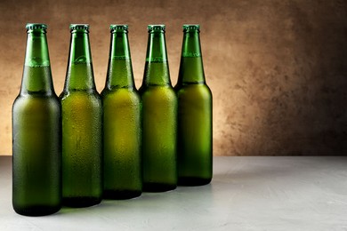 Photo of Many bottles of beer on white table, space for text