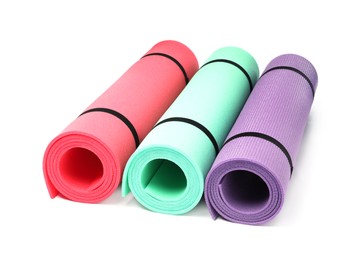 Colorful rolled camping or exercise mats on white background
