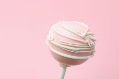 Sweet decorated cake pop on pink background