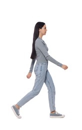 Photo of Woman in casual outfit walking on white background