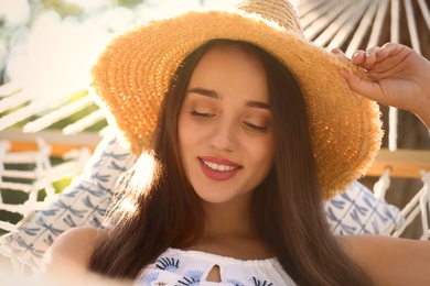 Young woman resting in comfortable hammock on sunny day, closeup