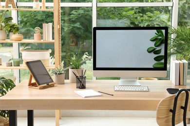 Comfortable workplace with computer in light room. Interior design