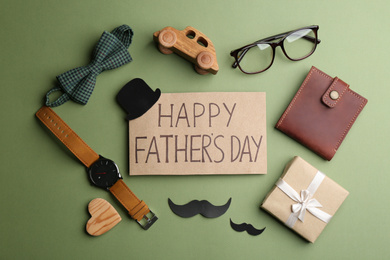 Flat lay composition with greeting card on green background. Happy Father's Day