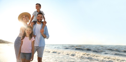 Happy family on beach near sea, space for text. Banner design