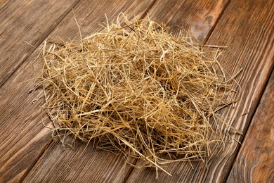 Photo of Pile of dried hay on wooden background