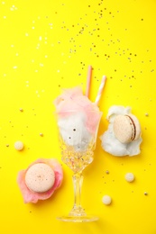 Flat lay composition with sweet cotton candy on yellow background