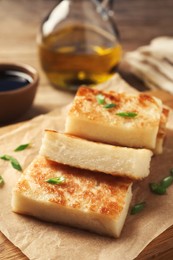 Delicious turnip cake with green onion on wooden board, closeup