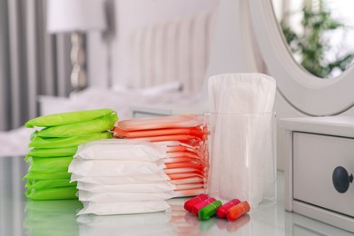 Different feminine hygiene products on dressing table in bedroom