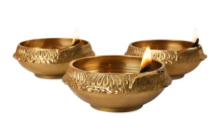 Photo of Lit diya lamps on white background. Diwali celebration