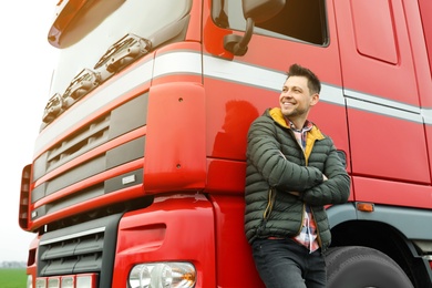 Photo of Portrait of happy driver at modern truck outdoors