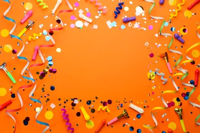 Frame of carnival items on orange background, flat lay. Space for text